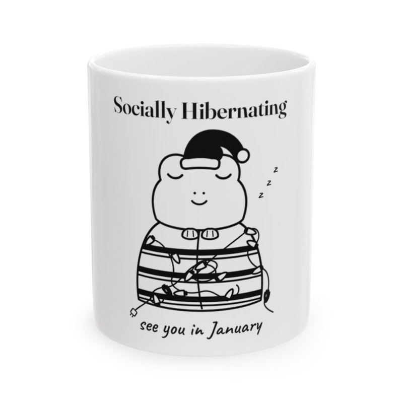 White mug printed with the Socially Hibernating Christmas frog in black and white